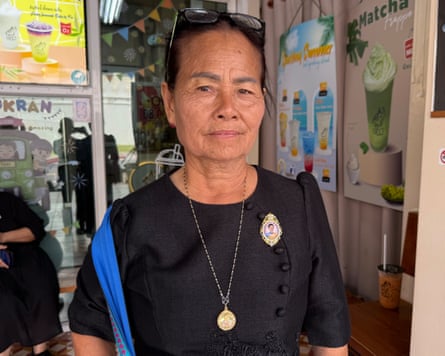 Wanida Lainun stands in a shop advertising ice drinks