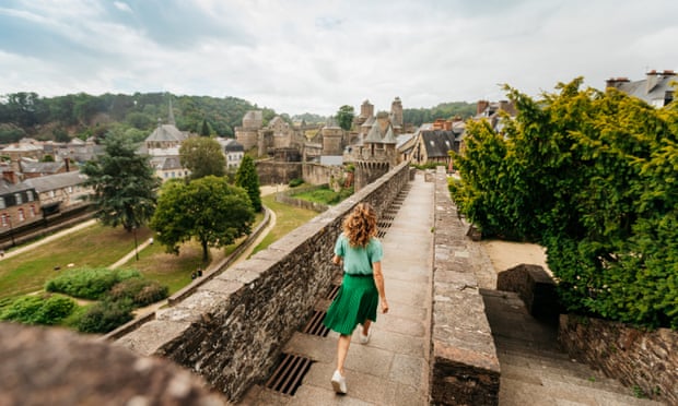 A woman walks along ramparts