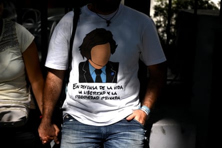 A man with his face in shadow holding a woman’s hand