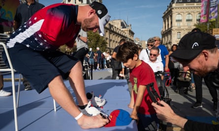 Matt Stutzman signs his hat for a young fan at Paralympic Day in Paris in October
