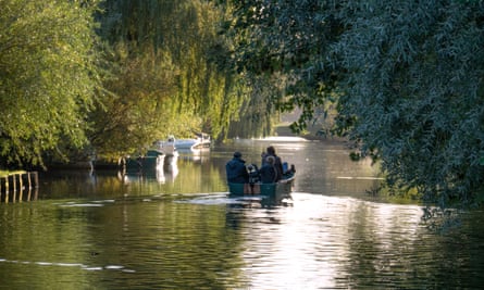 A boat on a tree-lined river