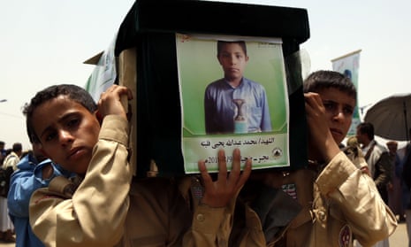 Boys carry the coffin of one of the dozens of child victims of a Saudi-led airstrike in Yemen