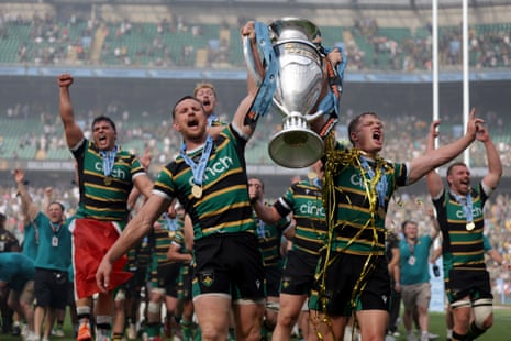 Northampton Saints players celebrate with the trophy on the pitch after the Gallagher PREM Final at the Allianz Stadium, London