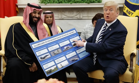 Donald Trump holds a chart highlighting arms sales to Saudi Arabia during a meeting with the crown prince, Mohammed bin Salman, at the White House, on 20 March 2018. 