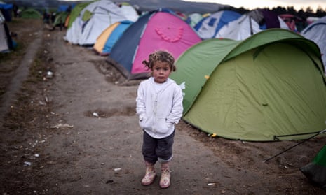 A child stands in a camp for migrants and refugees at the Greek-Macedonian border