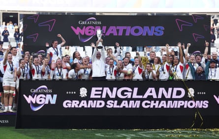 England's head coach John Mitchell lifts the trophy as he celebrates winning the Women’s Six Nations Championship with his players.