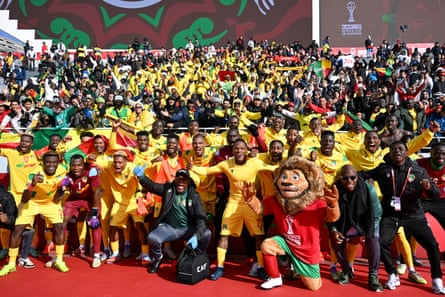 Benin players, supporters and the Afcon mascot, Assad, pose for a photo after the historic win against Botswana