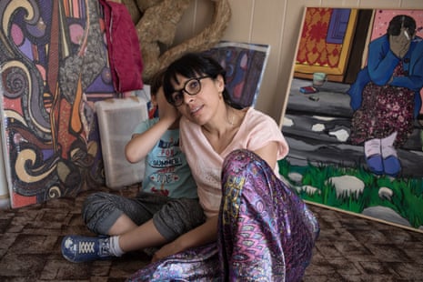 Polish Roma artist Gosia Mirga and her son Ignacy, six, with her paintings
