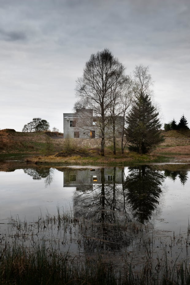 Exterior shot of Ardteatle with loch and trees reflecting in the water