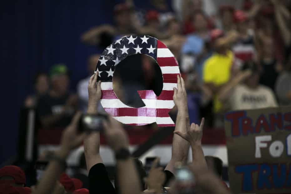 An attendee holds signs a Q sign at a Trump rally in Lewis Center, Ohio, 4 August 2018. 