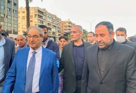 Syrian Foreign Minister Faisal Mekdad walks with Iran’s ambassador in Damascus Hossein Akbari near a damaged site after what the Iranian media said was an Israeli strike on a building close to the Iranian embassy in Damascus, Syria.