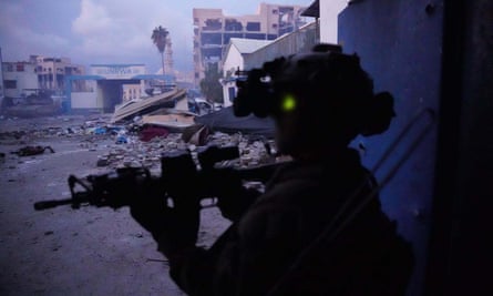 An Israeli soldier searches for Hamas fighters in Gaza City using night vision goggles, 15 February 2024.
