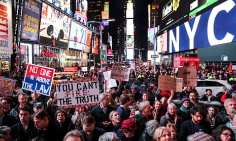 People take part in the ‘No one is above the law’ protest in Times Square, New York