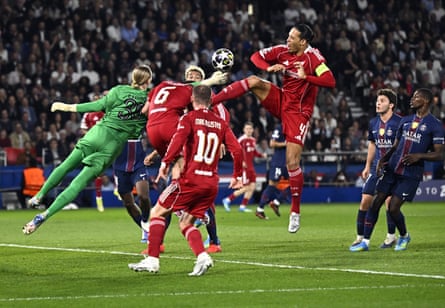 Virgil van Dijk (in yellow armband) tries to beat PSG goalkeeper Matvey Safonov in the air