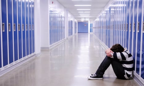 Depressed Boy in School Hallway