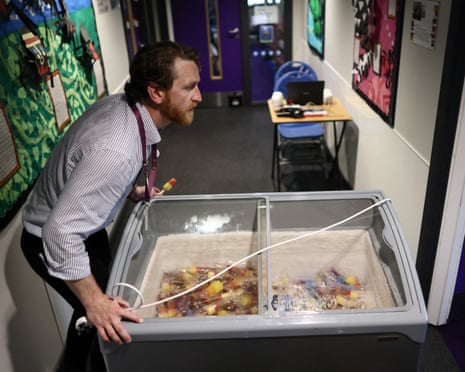 A teacher pushes a freezer of ice lollies into a class room at the Harris Academy Primary Mayflower school.