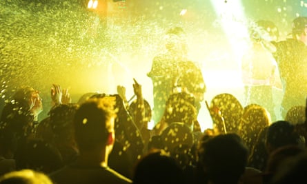 A crowd looking up at a performer on stage