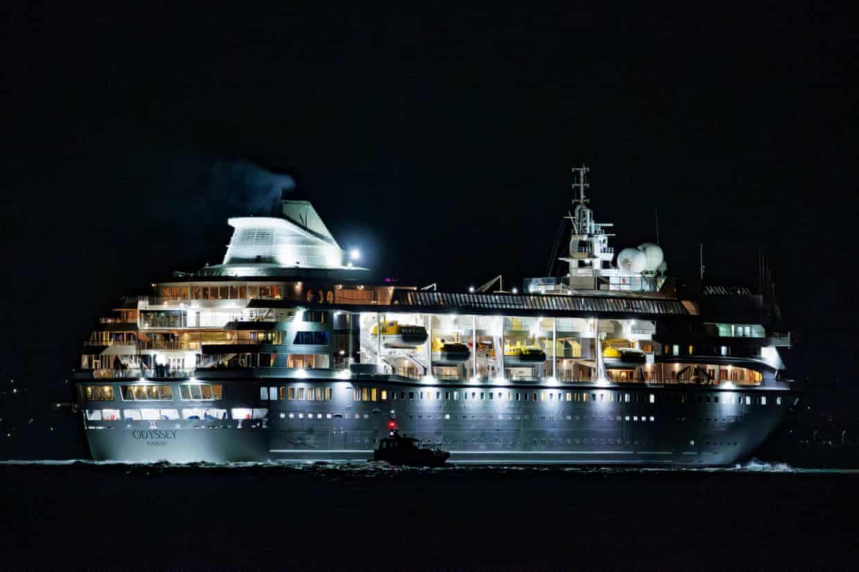 The Odyssey cruise ship, brightly lit, sails at night leaving Belfast Harbour