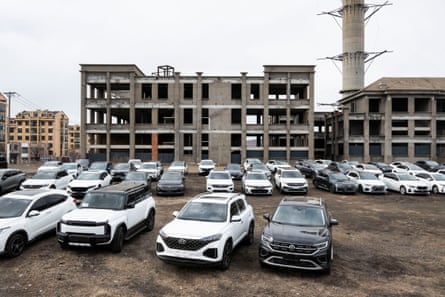 Cars parked outside a half constructed building