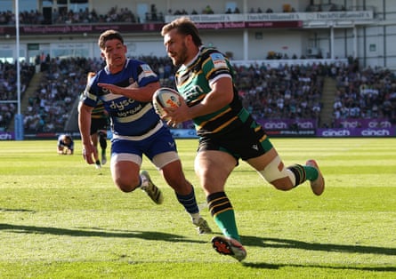 Ollie Sleightholme runs in a try for Northampton, with a Bath defender trying in vain to stop him, during Northampton’s 41-38 victory in Prem Rugby.