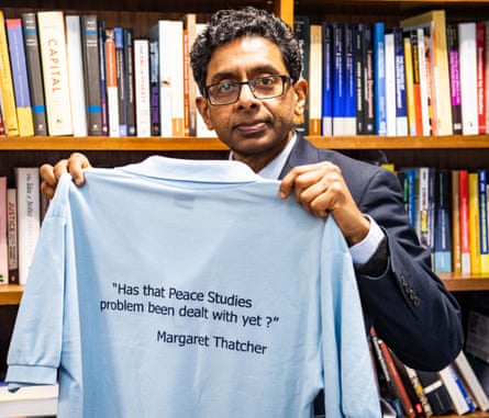 Prof Prathivadi Anand, head of the department of peace studies and international development, holding a T-shirt bearing a quote by Margaret Thatcher.