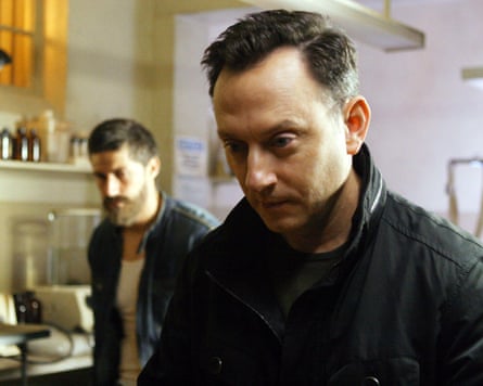 Interior shot with man in foreground with another man in background