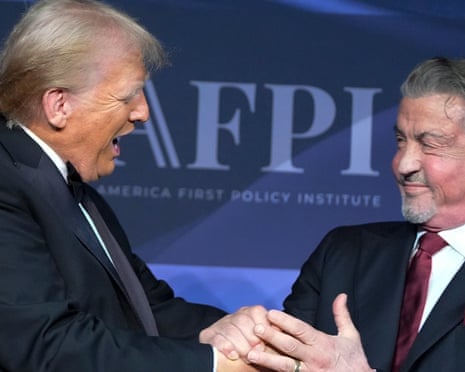 two men in suits and ties clasp hands
