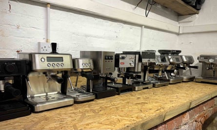 Several espresso machines lined up on a work surface
