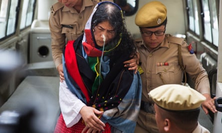 Irom Sharmila is escorted by police officers into a courtroom in Imphal.