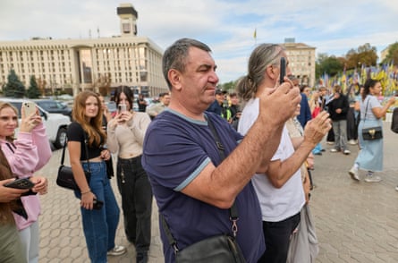 People film Harry during his visit to Maidan Square.