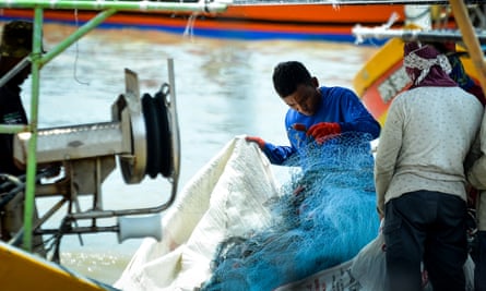 Fishermen inspect their nets in Kuala Muda, near the border between Penang and Kedah, Malaysia