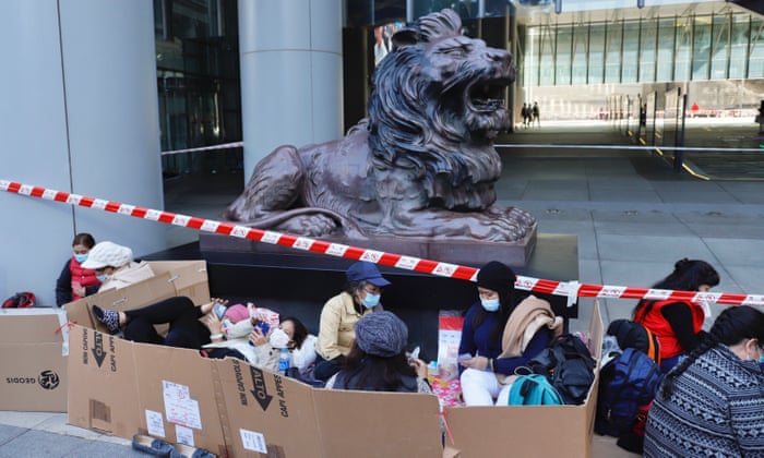 Covid: South Korea reports more than 100,000 new cases for first time – as it happened 5 Workers gather inside the make-shift partition outside HSBC headquarters in Hong Kong.