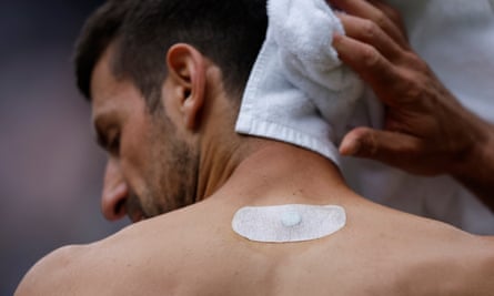 Novak Djokovic wearing a magnet on his back as he changes shirts in his victory over Andrey Rublev