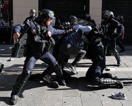 French riot police restrain a protester in Marseille
