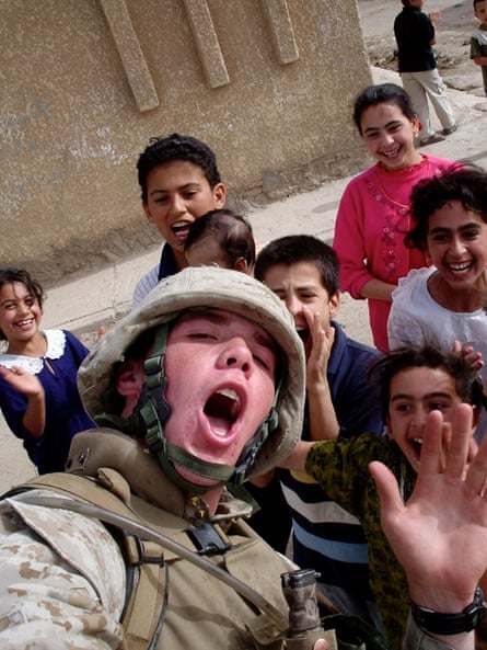 Collins, in military outfit, goofs around with children