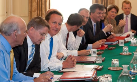 Heywood sits next to Cameron at a cabinet meeting in 2012.