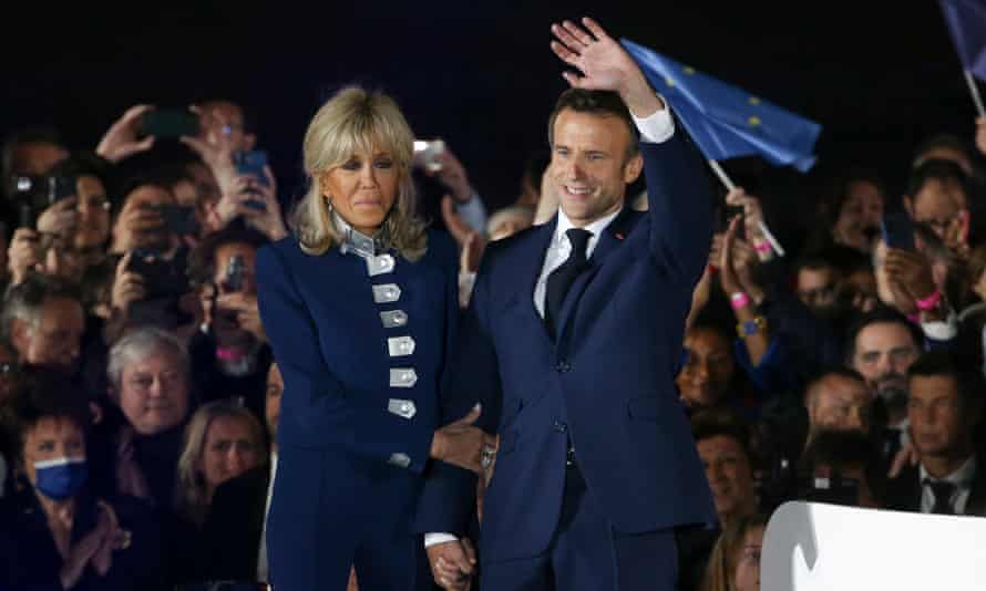 Emmanuel Macron and his wife, Brigitte, wave at wellwishers