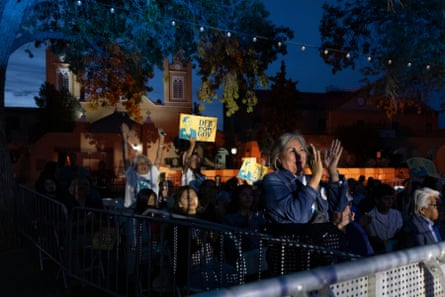 Supporters of gubernatorial candidate Deb Haaland cheer at a night-time election watch party