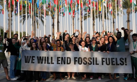 Members of Greenpeace gather for a photo at the Cop28 summit in Dubai.