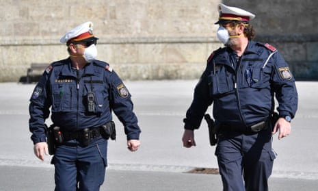Austrian police officers patrol the deserted streets of Salzburg.