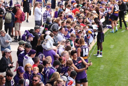 Bailey Banfield takes a selfie with Dockers fans at a training session at Cockburn ARC Oval.