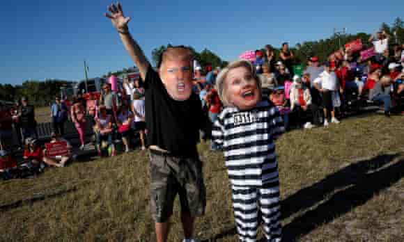 Craig Wendel dresses as Trump and his wife wears a Clinton mask as they support Trump at a campaign rally in Naples, Florida Sunday.