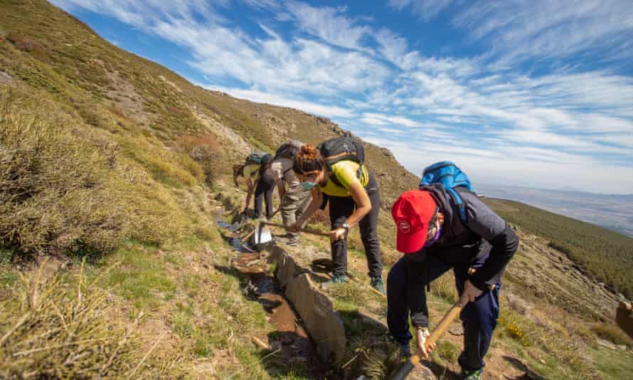 People clear irrigation channels at Jérez del Marquesado in the Sierra Nevada, Spain