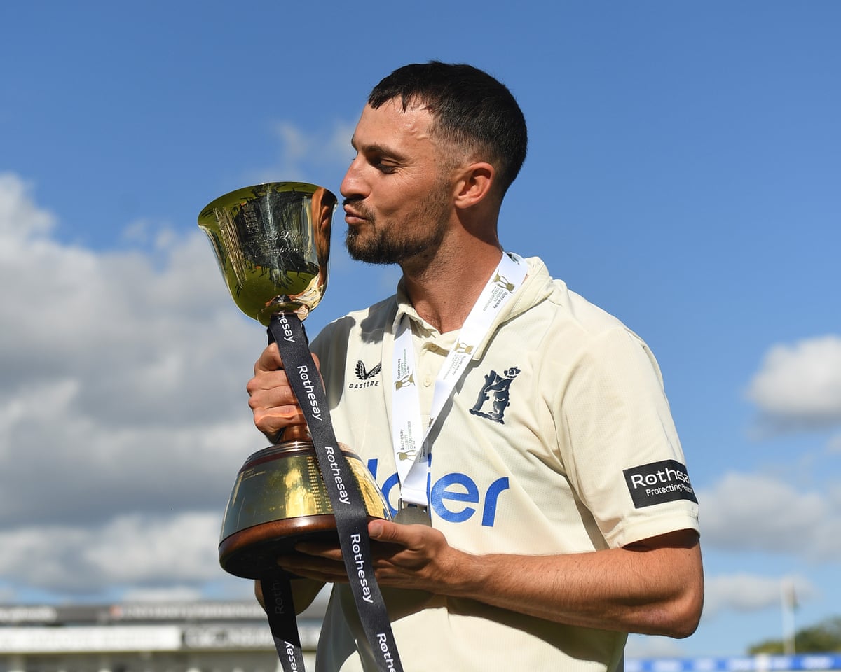 The Warwickshire captain, Ed Barnard, kisses the County Championship trophy after his team win the division by beating Leicestershire at Edgbaston.