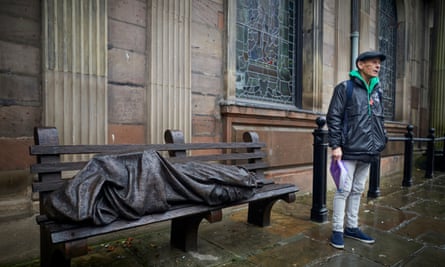 Danny Collins pictured at St Ann’s church with a bronze sculpture of Christ as a homeless person.
