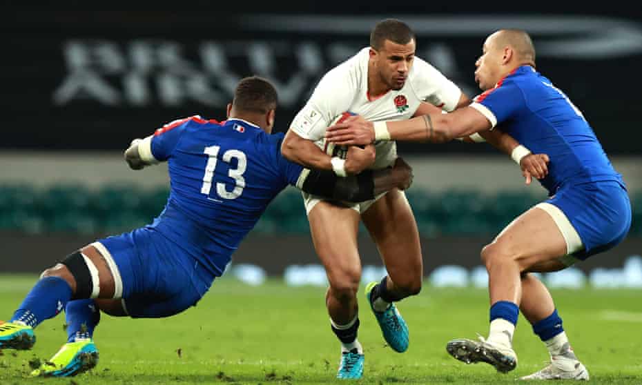 Anthony Watson is tackled by Virimi Vakatawa (left) and Gaël Fickou.