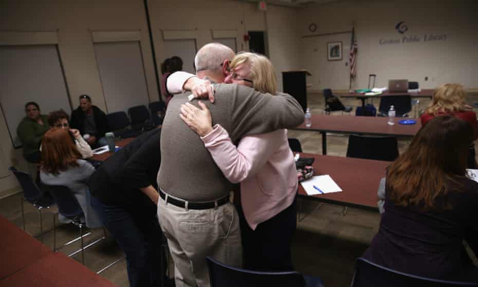 Parents of heroin and opioid addicts embrace during a family addiction support group on 23 March 2016 in Groton, Connecticut. 