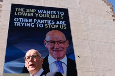 John Swinney, the SNP leader and Scottish first minister, launching an election poster today. The SNP claims that some of its policies, its call for the Scottish parliament to get more powers, and independence could all cut prices for people in Scotland.