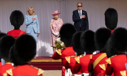 Joe and Jill Biden stand beside the Queen during a military arch past at Windsor Castle.
