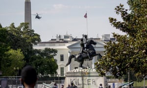 A presidential helicopter, the Washington Monument and the White House are visible behind a statue of Andrew Jackson in Lafayette Park Tuesday.